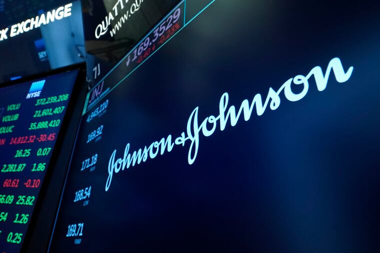 The Johnson & Johnson logo appears above a trading post on the floor of the New York Stock Exchange.