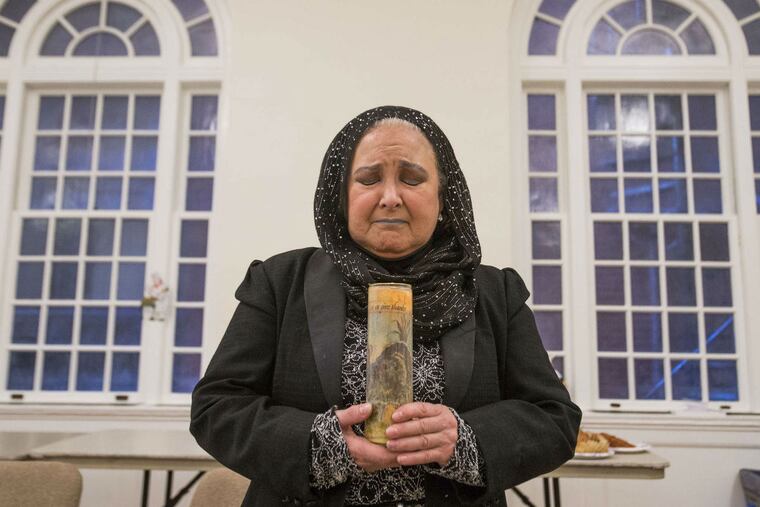 Olympia Saint-Auguste holds a Thanksgiving luminaire from her shrine for animals. She brought it to the potluck at the Ethical Society of Philadelphia.