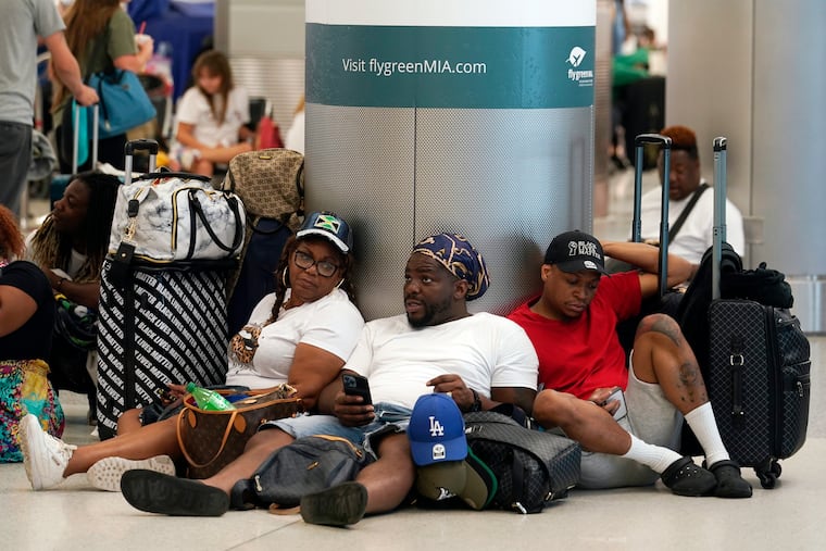 A group waits to check-in their luggage for their flight to Missouri at Miami International Airport on Saturday.