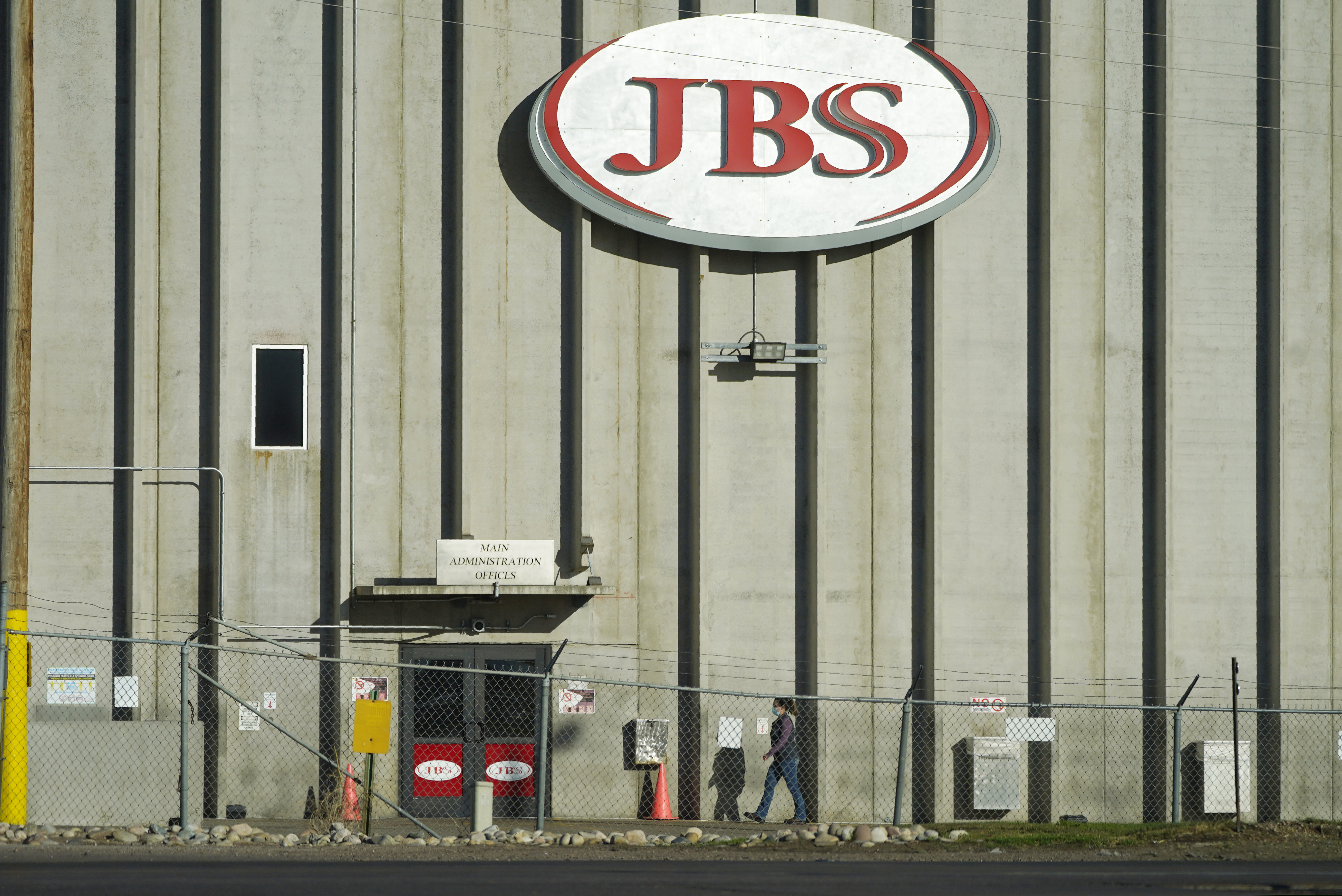 In this Oct. 12, 2020 photo, a worker heads into the JBS meatpacking plant in Greeley, Colo.