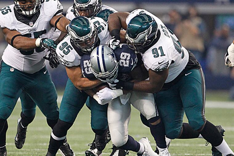 Eagles linebacker Mychal Kendricks and defensive lineman Fletcher Cox tackle Cowboys running back DeMarco Murray. (Ron Cortes/Staff Photographer)