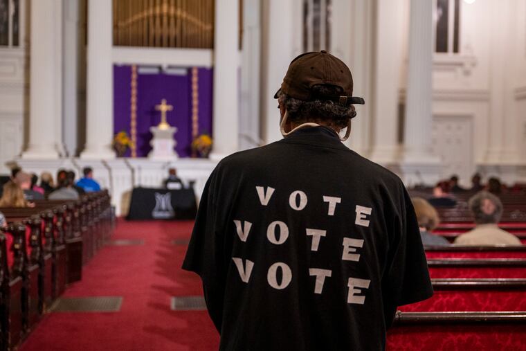 An attendee watches a mayoral forum at the Arch Street Presbyterian Church hosted by the Mazzoni Center. The city's mayor's race could come down to who gets out the vote in the final stretch.
