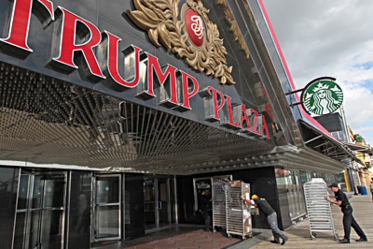 Racks of food are rolled into Trump Plaza, preparing to reopen Friday. MICHAEL BRYANT / Staff Photographer