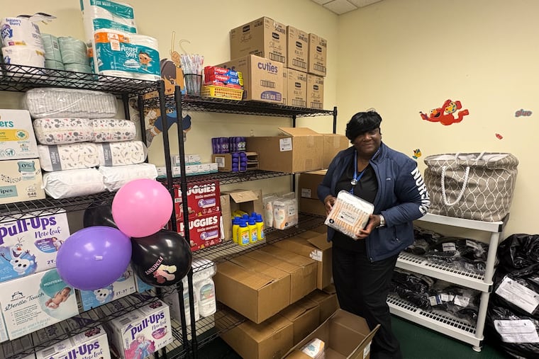 Trina Smith stocks diapers at Trinity Transitional House's diaper bank at the Christian Church of Chester in Chester.