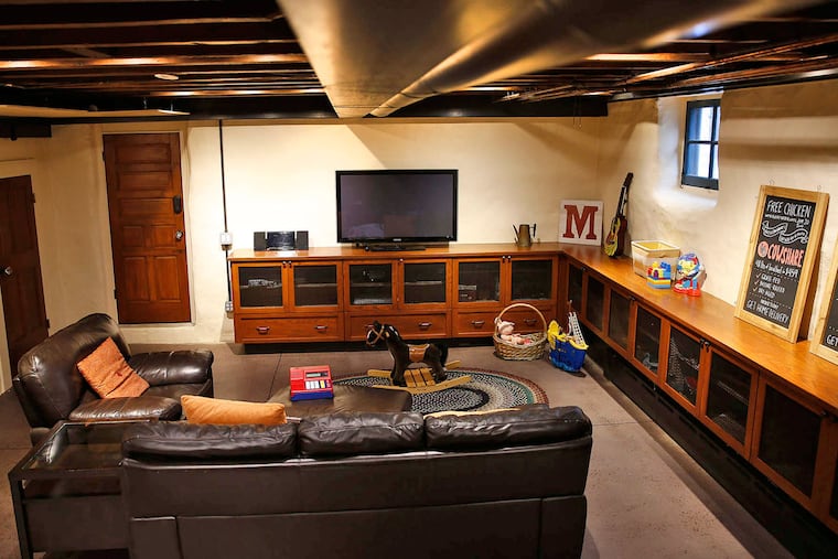The finished basement features a polished concrete floor in the home of Jon and Jessica Moore in Philadelphia on Aug. 18, 2016.