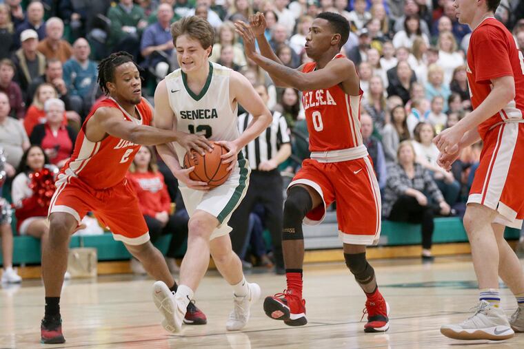 Delsea's Aziz Saud (2) and Nate Cox (0) defend against Seneca's Johnny Kennevan (12) during the NJSIAA South Jersey Group 3 championship game at Seneca High School in Tabernacle, N.J., on Tuesday, March 6, 2018. Delsea won 53-40. TIM TAI / Staff Photographer