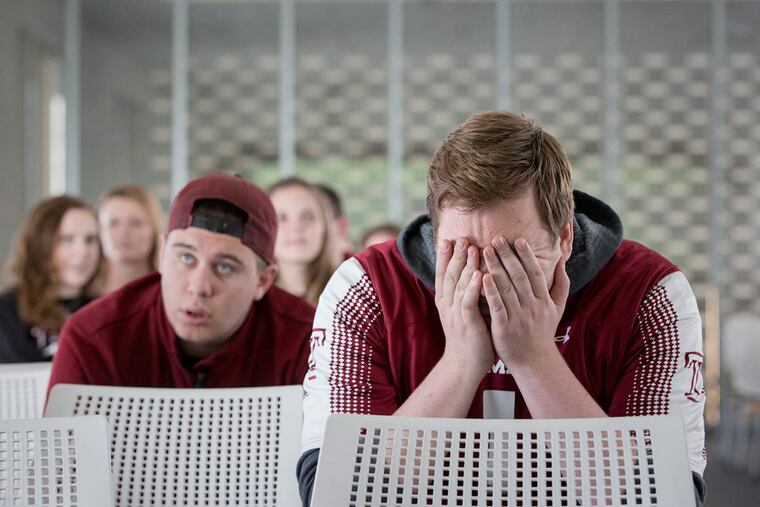 Saturday December 5, 2015 Temple fans react as the Owls lose to Houston in the AAC playoffs. Here at a viewing room at Temple's Morgan Hall seniors Eric Hamilton, right, and John Deorio watch as the game slips away in the second half.