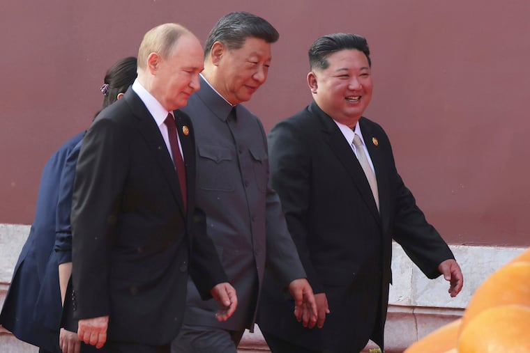 In this photo provided by the North Korean government, (from left) Russian President Vladimir Putin, Chinese President Xi Jinping, and North Korean leader Kim Jong Un walk to attend a Sept. 3 military parade marking the 80th anniversary of the end of World War II, at Tiananmen Square in Beijing.