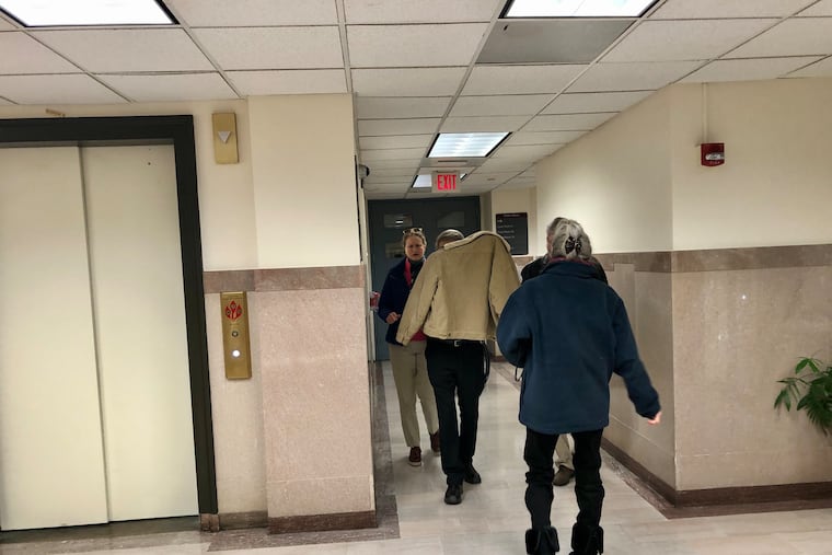 Harry Gramlich (center) shields himself from reporters as he leaves a courtroom in the Montgomery County Courthouse. Gramlich was found guilty of involuntary manslaughter in the death of his brother Timothy.