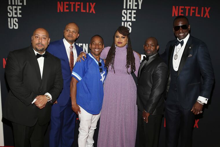 FILE- In this May 20, 2019 file photo, Director Ava DuVernay, center, with the Central Park 5: Raymond Santana, from left, Kevin Richardson, Korey Wise, Anthony McCray and Yuesf Salaam, attend the world premiere of "When They See Us," at the Apollo Theater in New York. A former prosecutor in the Central Park Five case has resigned from at least two nonprofit boards as backlash intensified following the release of the Netflix series "When They See Us," a miniseries that dramatizes the events surrounding the trial.