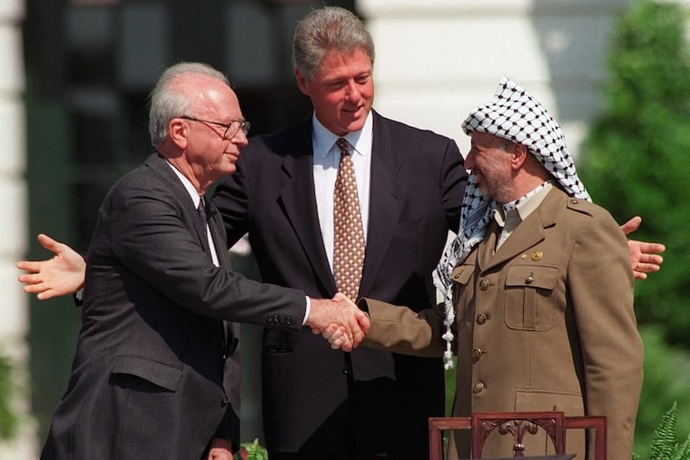 From left, Israeli Prime Minister Yitzhak Rabin, President Bill Clinton, and PLO chairman Yasser Arafat at the signing of the 1993 peace accords between Israel and the Palestinians. To fully grasp the current conflict, it's essential to acknowledge the contrasting narratives about Israel-Palestine, Jonathan Zimmerman writes.