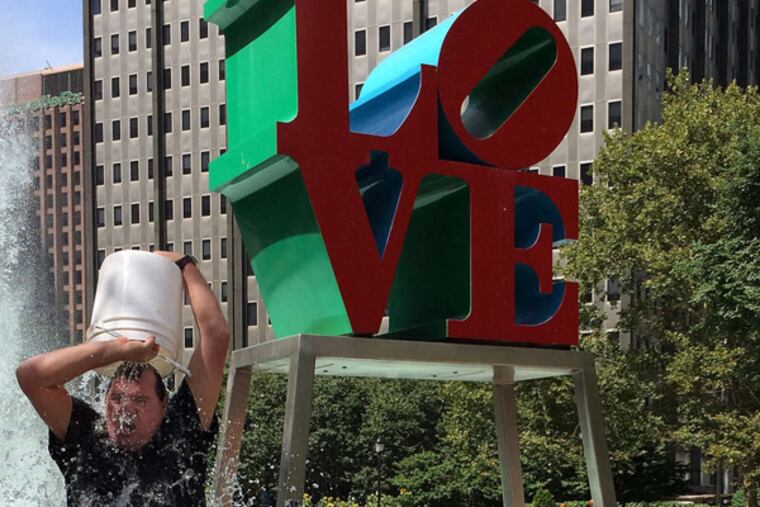 Brent Cronin of Fishtown takes the ALS Ice Bucket Challenge in front of the 'LOVE' sculpture Monday.