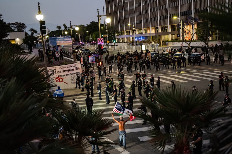 Law enforcement officers stand guard outside a detention center in Los Angeles on June 10, the day a curfew took hold following clashes in days prior between protesters and law enforcement.