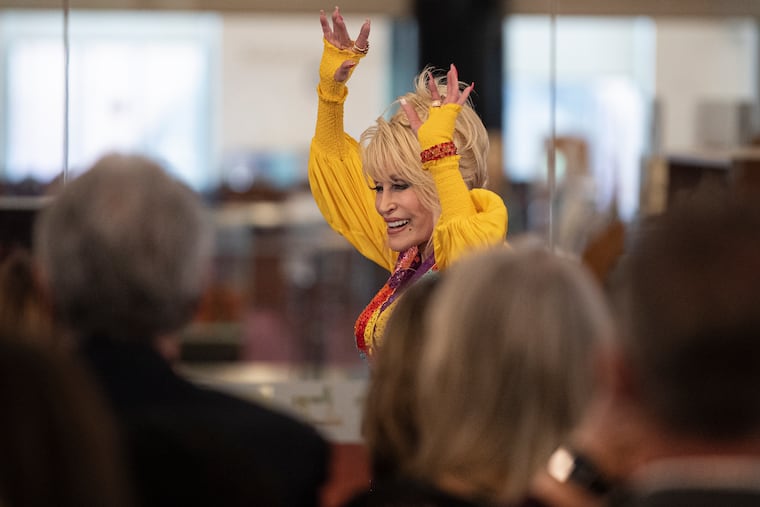 Dolly Parton waves to her fans on Thursday, May 5, 2022., at the Wilmington Public library in Wilmington, DE. Parton join Delaware Gov. John Carney to promote her Imagination Library, a free book gifting program for children.