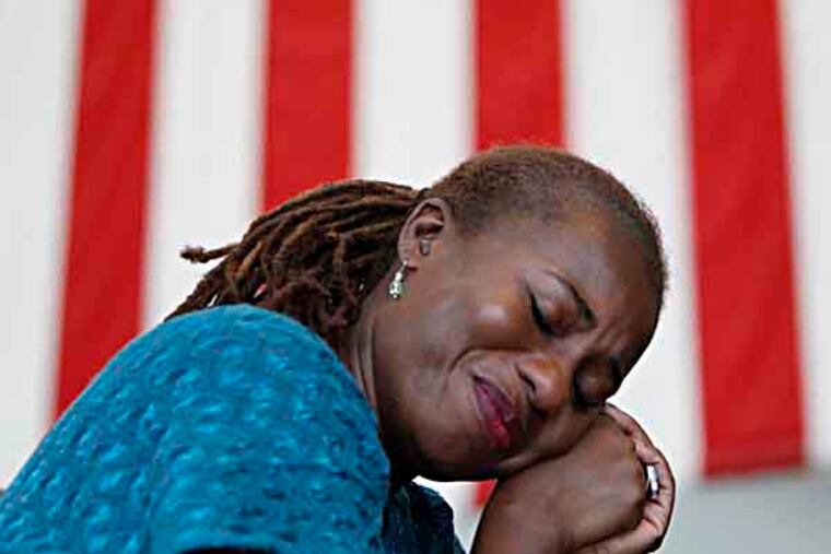 Tanya O'Neill, of Abington, Pa., reacts as singer Alexis P. Suter performs a song sung during the 1963 March on Washington during a 50th anniversary event of the Martin Luther King Jr. "I Have a Dream" speech at the National Constitution Center in Philadelphia on August 28, 2013. ( DAVID MAIALETTI / Staff Photographer )
