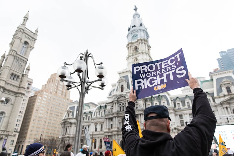 Workers rally in February 2018 ahead of the Janus v. AFSCME Supreme Court decision. A year after the decision, many local unions have lost revenue, but have increased the number of full dues-paying members.