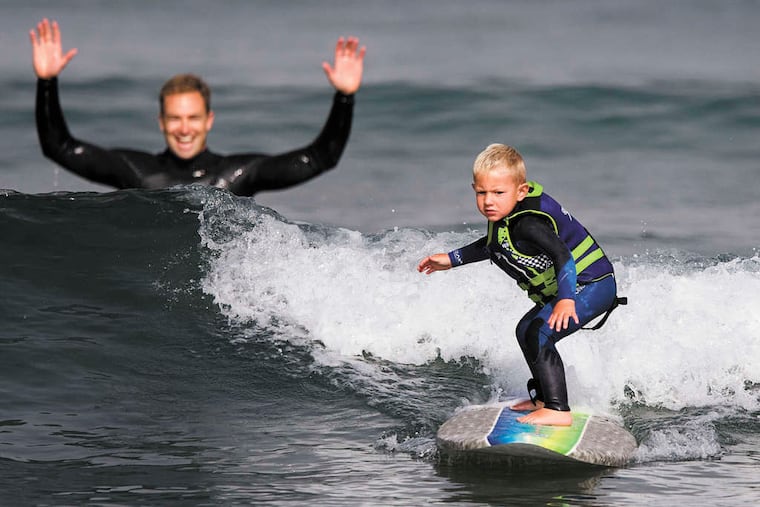 Triston Gailey, 3, surfs a wave as his father, Todd, watches in Morro Bay, Calif. "He's the most coordinated 3-year-old I've ever seen," says the 35-year-old fire captain/paramedic.