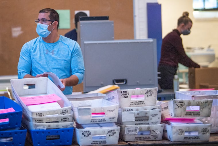 Poll workers count ballots inside the Ehinger Gym at West Chester University in West Chester in 2020.