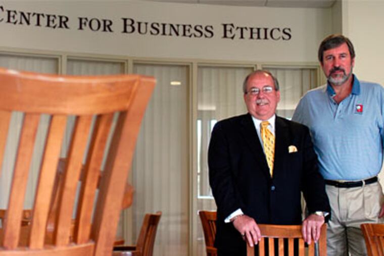 St. Joseph's University Dean Joseph A. DiAngelo and John J. McCall, Director of the Pedro Arrupe Center for Business Ethics, are helping colleges change the way they teach ethics (Tom Gralish / Inquirer)
