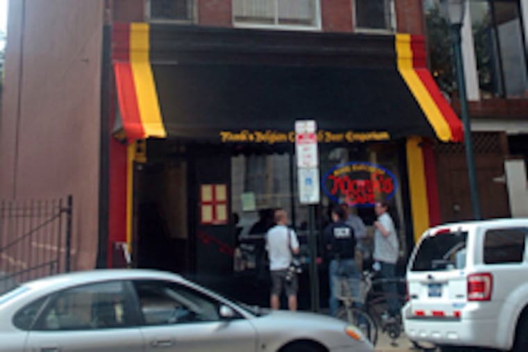 Two people fell from the fourth floor of this building, which houses Monk's Cafe, in the 200 block of S. 16th Street early this morning. (Sarah J. Glover / Staff Photographer)