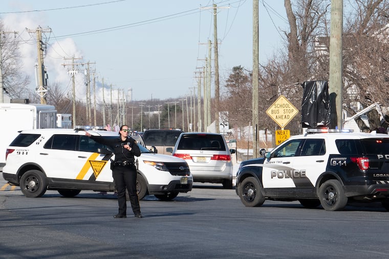 Police redirect traffic near the location of a report of an active shooter situation at a UPS facility in Gloucester County.