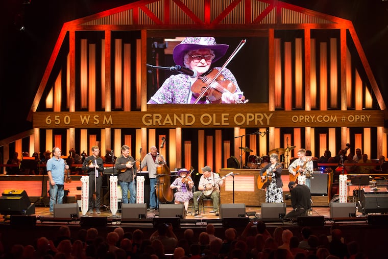 In a photo provided by Chris Hollo/Grand Ole Opry shows, Violet Hensley, at 99, achieved a long-held goal by performing at the Grand Ole Opry in Nashville, Tenn., in 2016. Hensley, who grew up in Arkansas learning from her father how to carve and play a fiddle, died on Aug. 7, 2026, at her home in Yellville, Ark., in the Ozarks. She was 109.