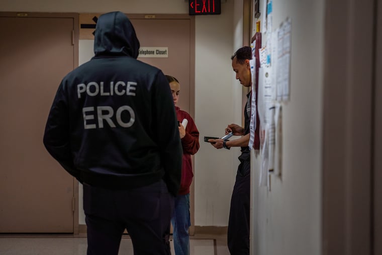 An officer with Enforcement and Removal Operations, part of Immigration and Customs Enforcement, stands in an immigration court hallway at Federal Plaza in Lower Manhattan, May 26, 2026. The Trump administration said on Friday, June 12, 2026, that it would comply with a court order to restart processing asylum and other immigration applications filed by a broad swath of people who had been left in legal limbo for months.