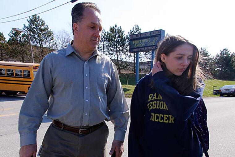 Jenna Mickel, right, a sophomore at Franklin Regional High School, stands with her father, Richard, as she talks with reporters near the school, where 20 people were wounded in a stabbing rampage, Wednesday, April 9, 2014, in Murrysville, Pa., near Pittsburgh. (Gene Puskar/Associated Press)