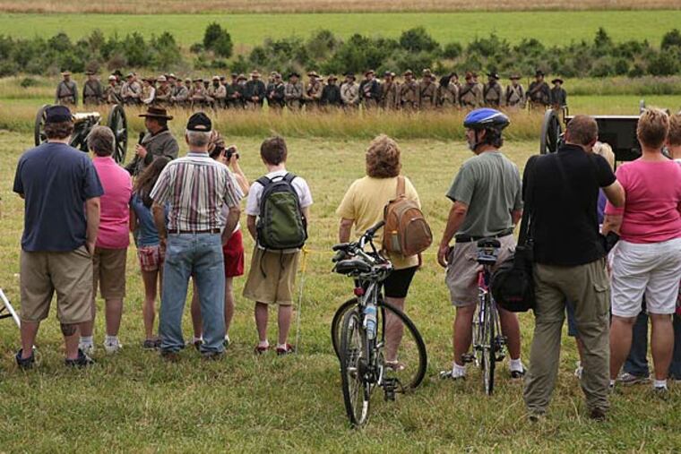 Tourists watch a re-enactment of the Battle of Gettysburg, fought 150 years ago this week.