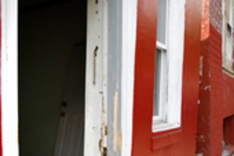 Knocked off its hinges is the door to the last known address of wanted suspect Eric Floyd.