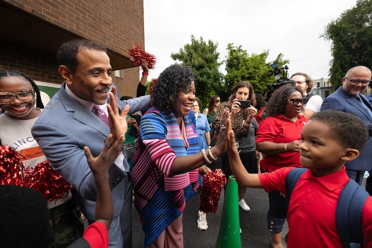 Superintendent Tony B. Watlington Sr. and Mayor Cherelle L. Parker greet a student on the first day of the academic year in August 2025 at the Edward T. Steel School in Nicetown.