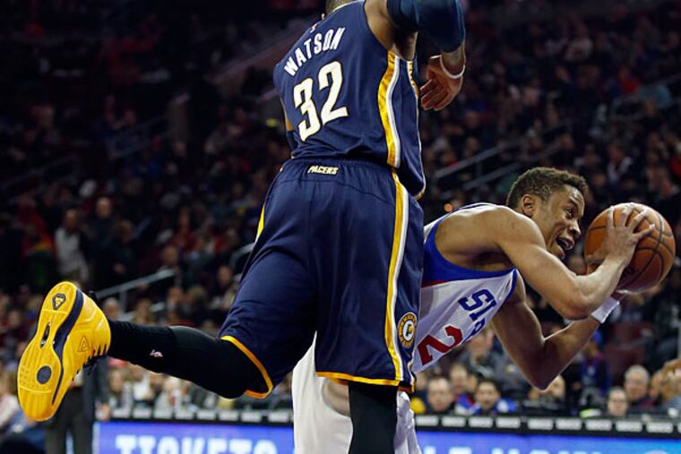 Sixers' Tim Frazier gets fouled shooting the basketball against Pacers' C.J. Watson. (Yong Kim/Staff Photographer)