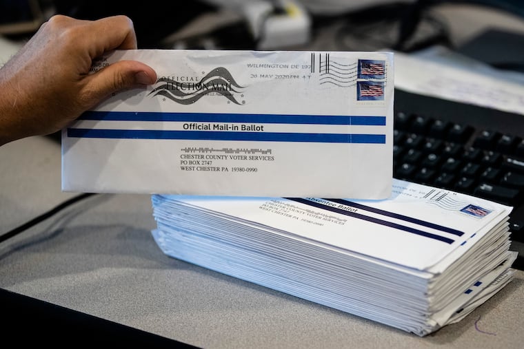 This May photo shows mail-in primary election ballots being processed at the Chester County Voter Services office in West Chester.