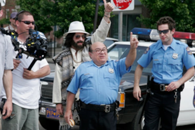 On break from shooting near South Street, Danny DeVito and costars from "It's Always Sunny in Philadelphia" wave to onlookers.