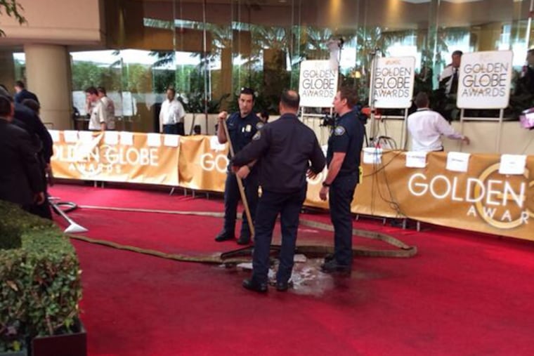 Several photos of the disgusting spill were posted to Twitter by the likes of Ryan Seacrest and Cosmopolitan magazine. "Huge water leak on #goldenglobes red carpet...Bev Hills fire trying to clean up," Seacrest tweeted at about 5 p.m. (Photo: Ryan Seacrest via Twitter)