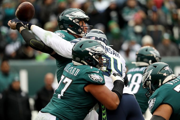 Eagles quarterback Carson Wentz is hit by Seattle defensive end Ezekiel Ansah as he tries to throw during the loss on Nov. 24.