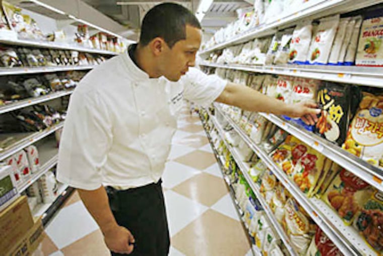 Judson Branch, chef of Thirteen at the Center City Marriot, stopped by the H-Mart Korean Grocery to point out the variety of specialty products available at ethnic markets. (ALEJANDRO A. ALVAREZ / Staff photographer)