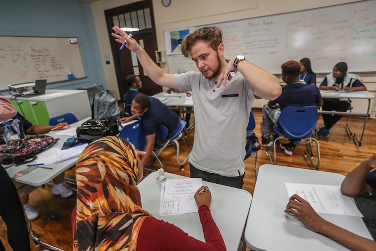 Vaux Big Picture High School teacher Amit Schwalb, center, leads his students in an exercise to create a family tree to learn about graphing.