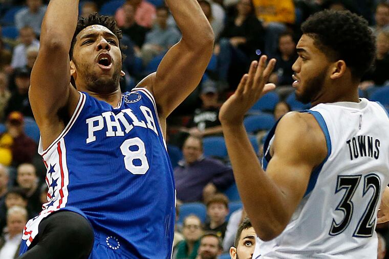 The Sixers' Jahlil Okafor , shooting over Minnesota's Karl-Anthony Towns, had 25 points and 12 rebounds Monday. He is averaging 18.4 points through the season's first 15 games, all losses. STACY BENGS / AP