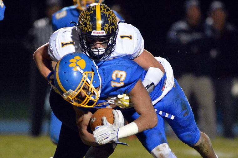 Unionville’s Joe Zubillaga (1) takes down Springfield’s Ja’Den McKenzie (13) in last week’s PIAA District 1 Class 5A final.