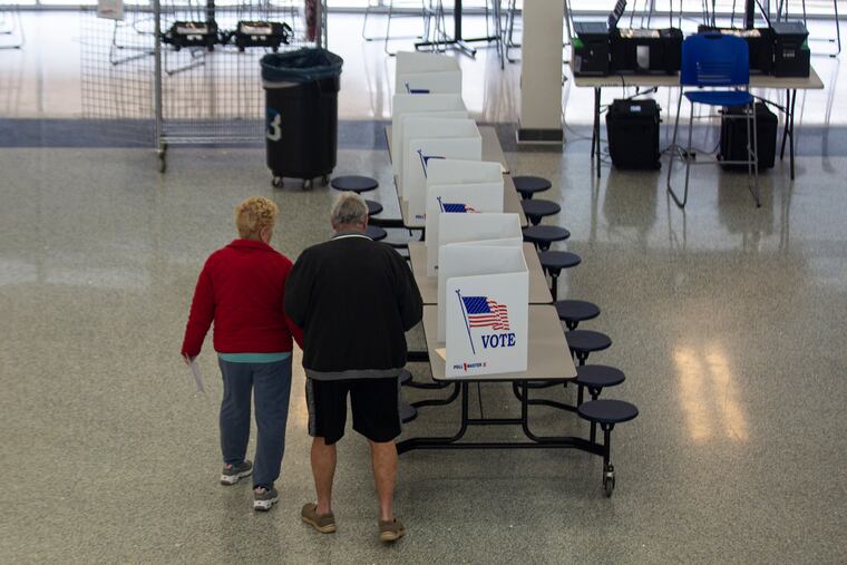 People in the community come out to vote at the poll stations in Bensalem High School for Bucks County special election on Tuesday, March 17, 2020. Despite the countless requests from Governor Wolf and other officials, a few people came out to vote during the coronavirus pandemic.