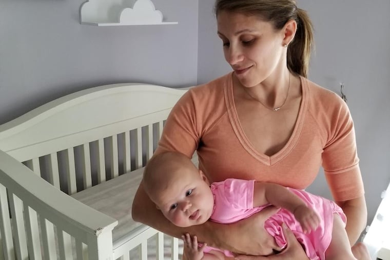 Aimee Bergner of Palmyra, Lebanon County, cradles her baby, Lenore, 5 months, in a side hold to comfort her. This is one of the strategies Bergner was taught to calm a fussy baby as a participant in the INSIGHT study conducted by Penn State.