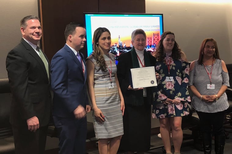 Sister Helen Cole, fourth from right, and members of the Guadalupe Family Services, a non-profit agency that operates in Camden, received the FBI Director’s Community Leadership Award Friday from FBI Philadelphia Special Agent in Charge Michael Harpster.