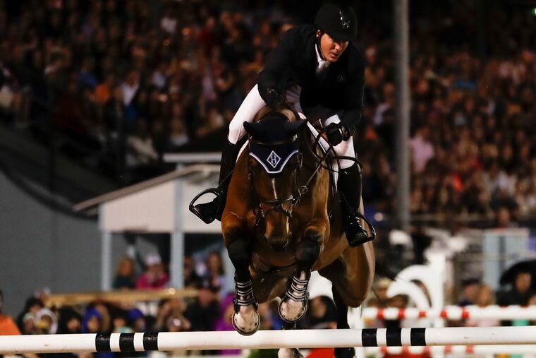 HH Azur, ridden by McLain Ward, jumps during the Sapphire Grand Prix of Devon at the Devon Horse Show and County Fair.