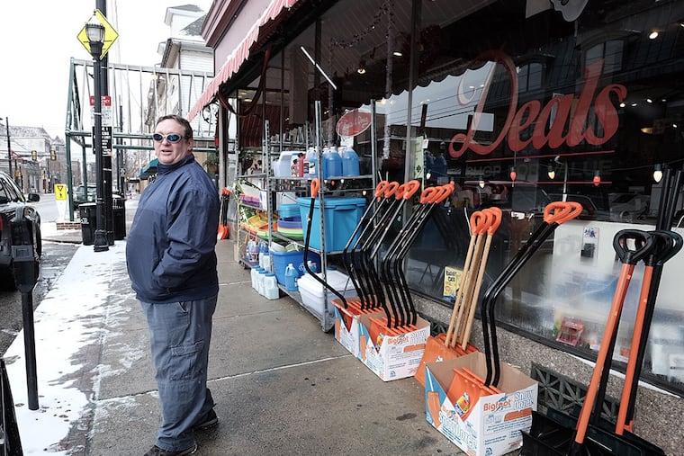 Eric Fedor of Media stands outside Deals Dept Store on State Street Tuesday morning and laments about the storm that wasn't. He blamed forecasters for blowing the storm out of proportion. (ED HILLE / Staff Photographer )