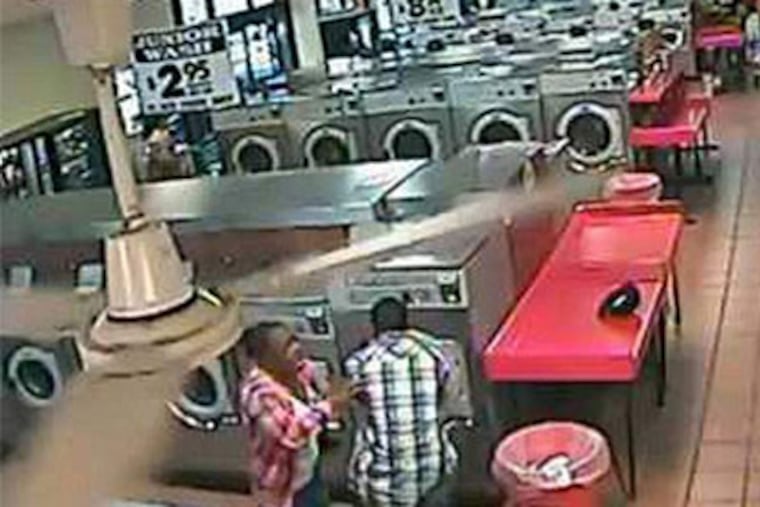 A video grab of the scary moments. The boy appeared unhurt. The video was posted by the laundromat owner's son.