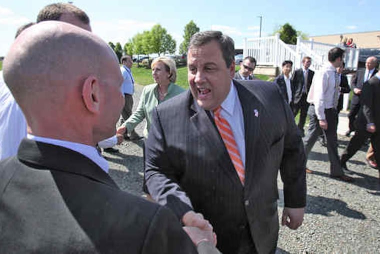 In Moorestown, Gov. Christie pumps the hand of Steve Lundholm of Lockheed Martin's business development office.Christie hailed the national defense contractor as a company that has put down "deep roots" in New Jersey.