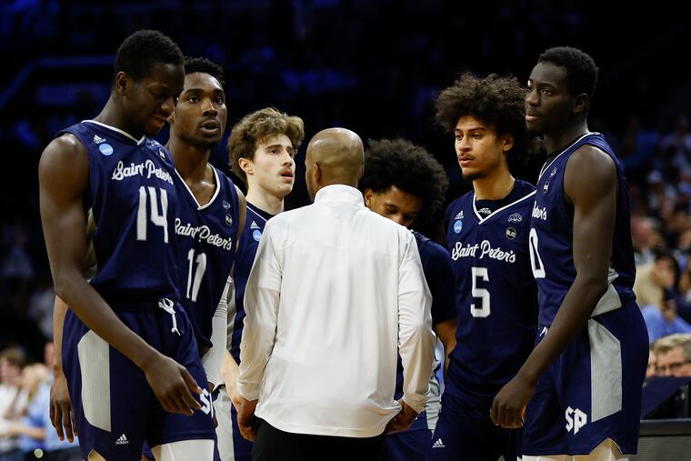 St. Peter's coach Shaheen Holloway gathers his players late during the second half against North Carolina.