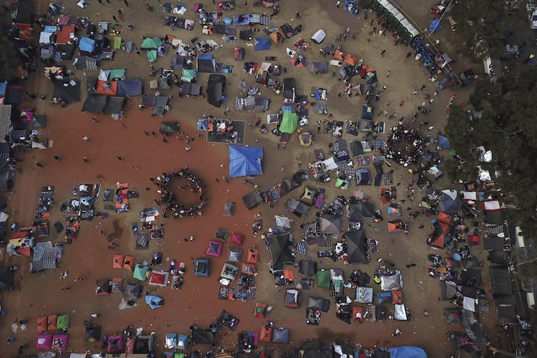 Central American migrants gather in an area designated for them to set up their tents in Tijuana, Mexico, Wednesday, Nov. 21, 2018. Migrants camped in Tijuana after traveling in a caravan to reach the U.S are weighing their options after a U.S. court blocked President Trump's asylum ban for illegal border crossers.