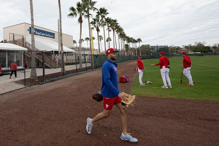Justin Crawford walk on to the field during the first day of spring training for pitchers and catchers on Wednesday in Clearwater, Fla. The 22-year-old is expected to be the Phillies' opening-day center fielder.